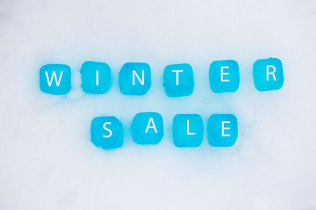 Photo directly above view of winter sale text on snow
