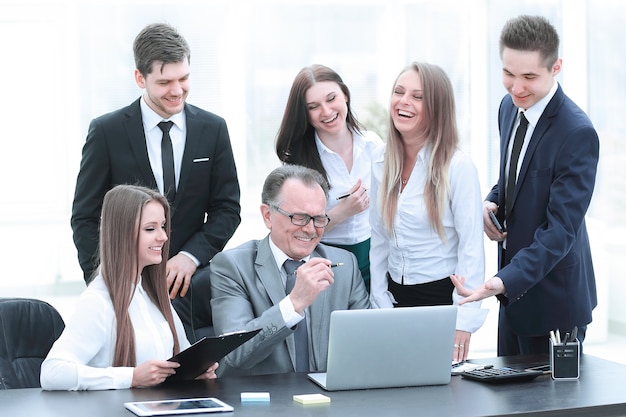 Director and business team looking at laptop screen.office weekdays