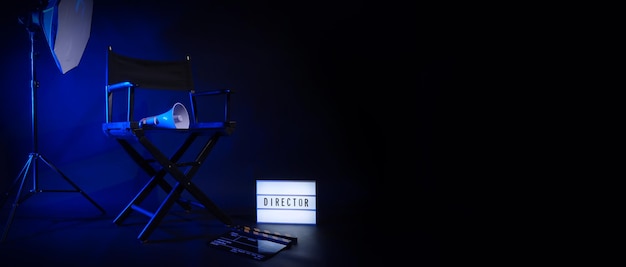 Director chair with cinema lightbox sign Director text on it and clapperboard megaphone