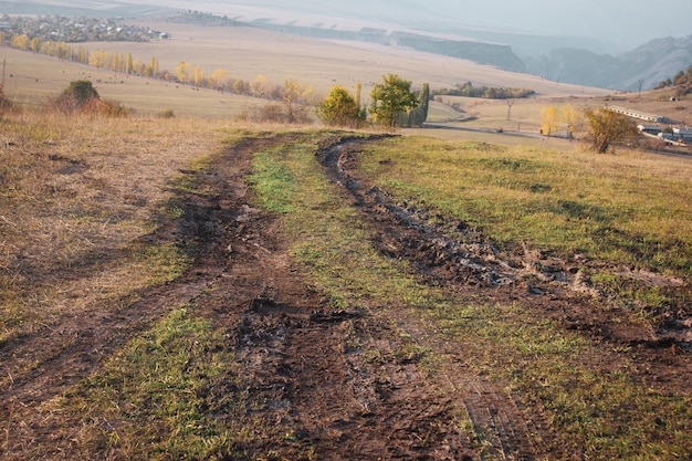 Dirt dirt road running through the field