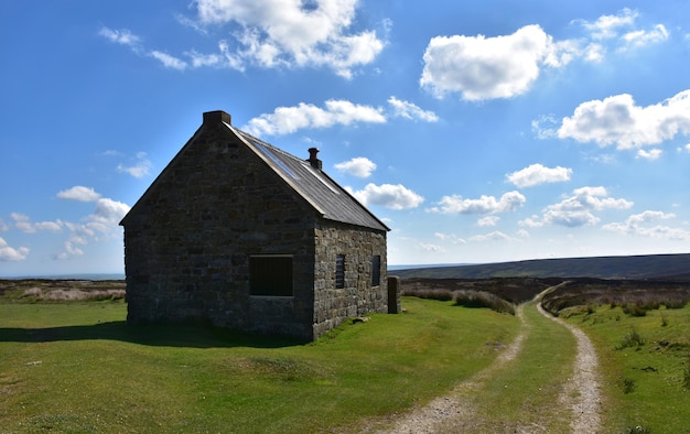 Dirt hiking trail by a remote cottage in Northern England.