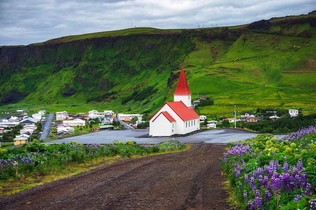 Dirt road going to the village of Vik and its church in Iceland