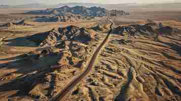 Photo a dirt road leads into a desert landscape