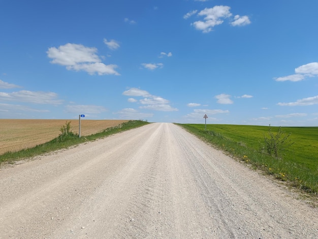 A dirt road with a blue sign that says " blue " on it.