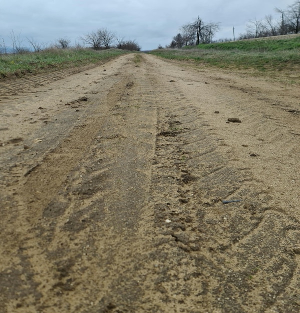 A dirt road with a few tracks in it