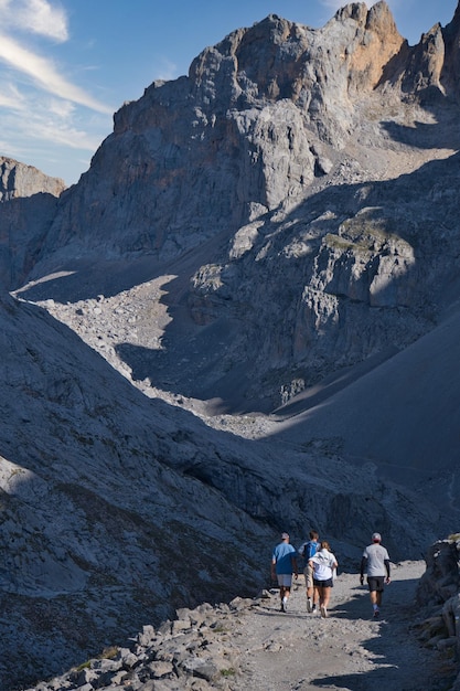 Dirt road with people walking in the mountains