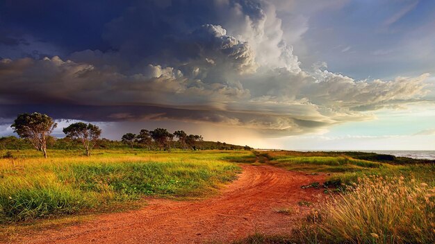 a dirt road with a sunset in the background