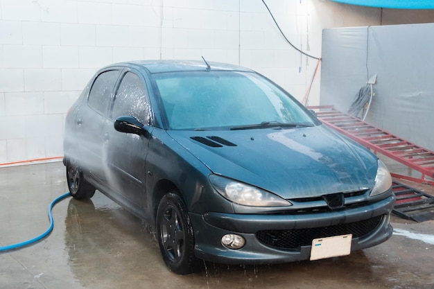 Dirty car being washed in the car washer