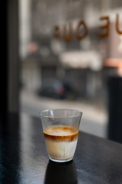 Dirty Coffee - A glass of espresso shot mixed with cold fresh milk in coffee shop cafe and restauran