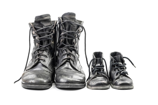 Dirty combat boots for adult and kid isolated on white background with clipping path