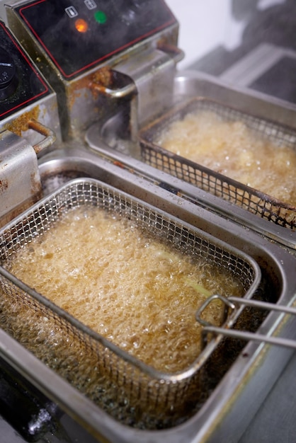 Dirty cooking area with french fries deep fryer