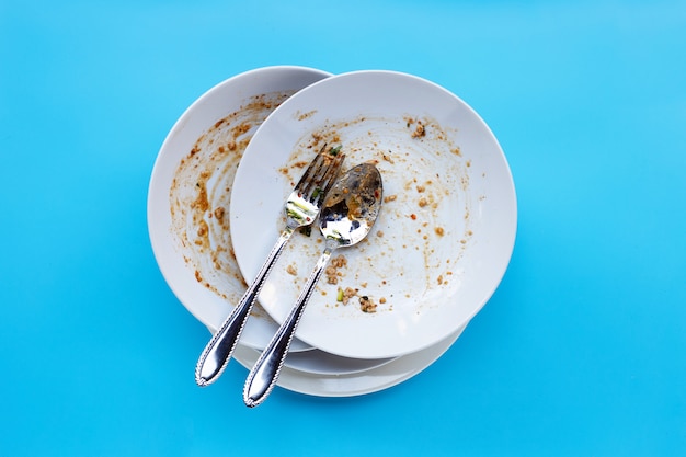 Dirty dishes on blue background.