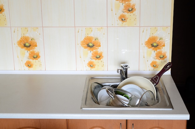 Dirty dishes and unwashed kitchen appliances filled the kitchen sink