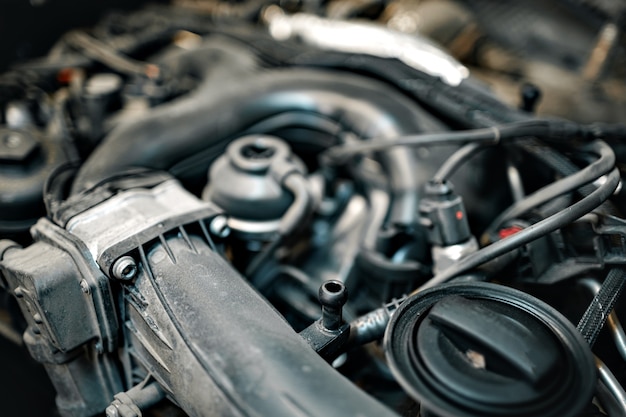 Dirty engine under the hood of a car close up