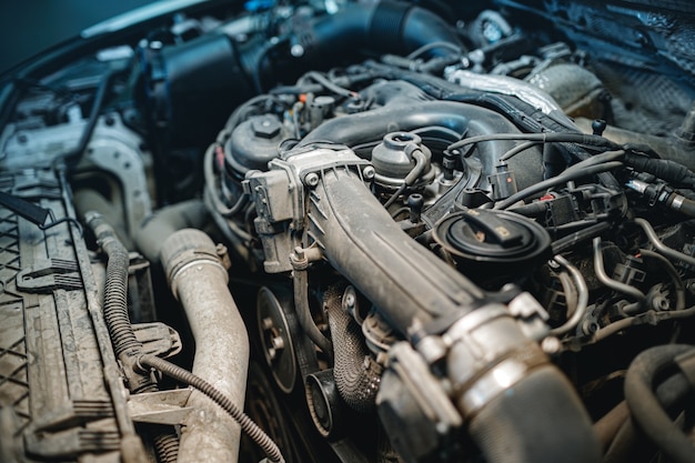 Dirty engine under the hood of a car close up