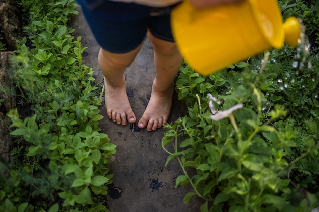 Piedi sporchi di una ragazza da vicino sul percorso in giardino