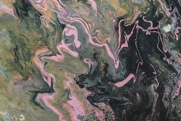 Dirty fluid art background with dark green, orange and pink tints and black stains. Eerie effect of acrylic paints. Liquid ink of bog tones. Toxic surrealistic abstract texture with mix marsh colors.