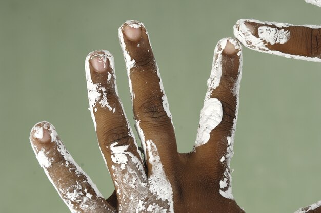 Dirty hand of a teenage girl painting