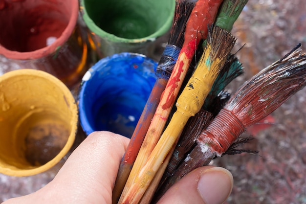 Dirty Paint brushes and paint containers on technique ebru art