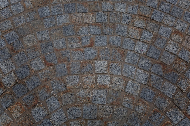 Dirty paving slabs. View from above. wall. Space for text.