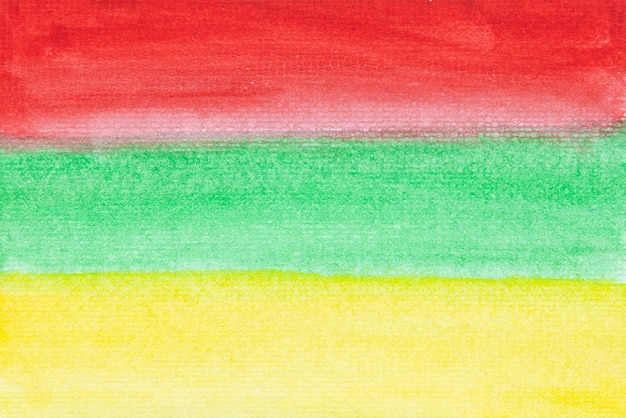 Dirty red green and yellow watercolor painting on paper background