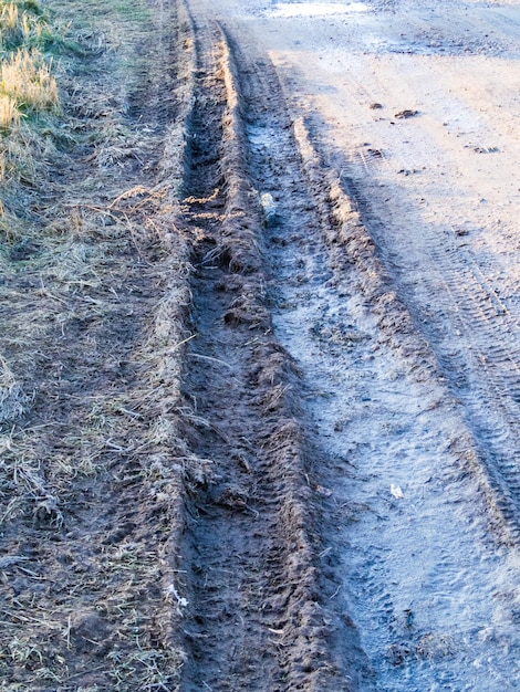 Dirty rural road with deep tire tracks