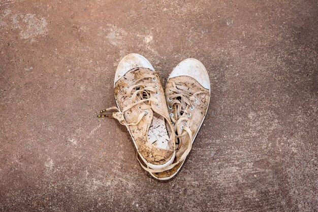 Dirty shoes, muddy mud and hay