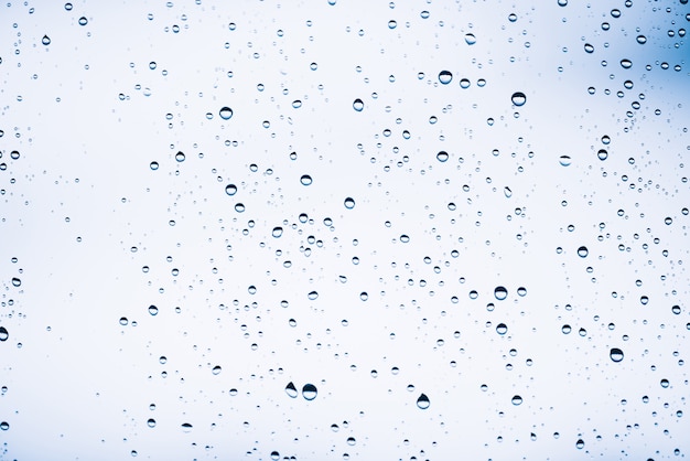 Dirty window glass with drops of rain