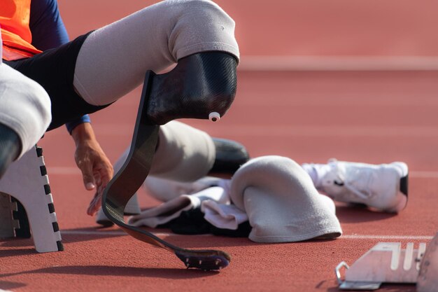 Photo disabled athletes prepare in starting position ready to run on stadium track