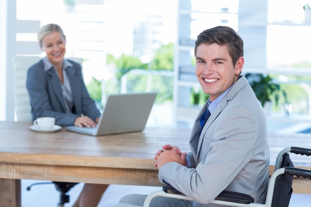 Disabled businessman working with partner