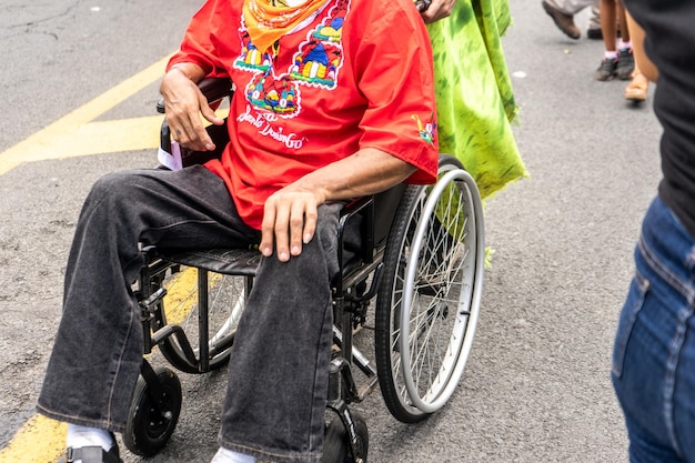 Пожилой мужчина-инвалид в инвалидной коляске в традиционной одежде из Никарагуа