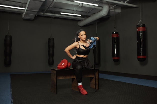 A disabled girl is engaged in the gym A woman with one leg trains with a trainer, she works hard and does not give up in front of trouble