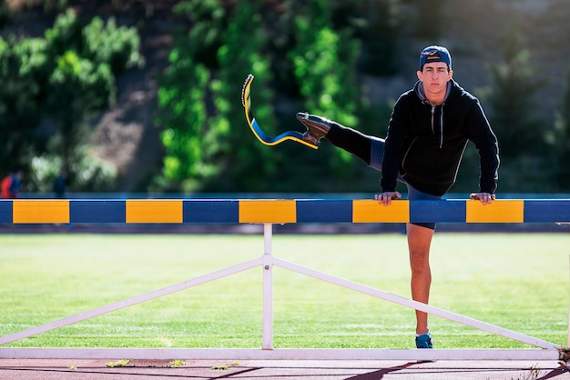 Disabled man athlete training with leg prosthesis. Paralympic Sport Concept.