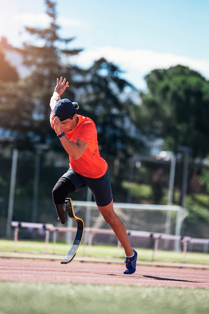 Disabled man athlete training with leg prosthesis.