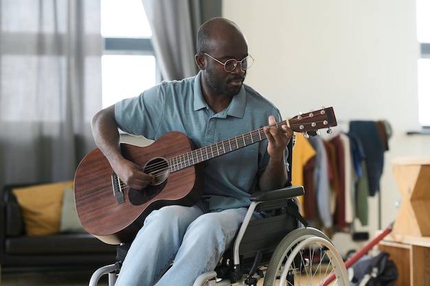 Disabled man enjoying playing guitar