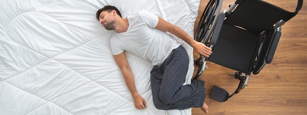 The disabled man laying on the bed view from above