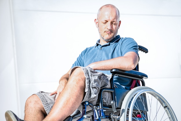 Disabled man with handicap on wheelchair in depression moment