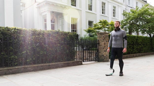 Disabled man with prosthesis full shot