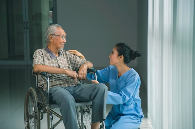 disabled old man talking with his nurse