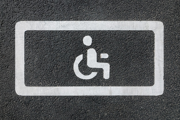 Foto segno di parcheggio disabili su asfalto