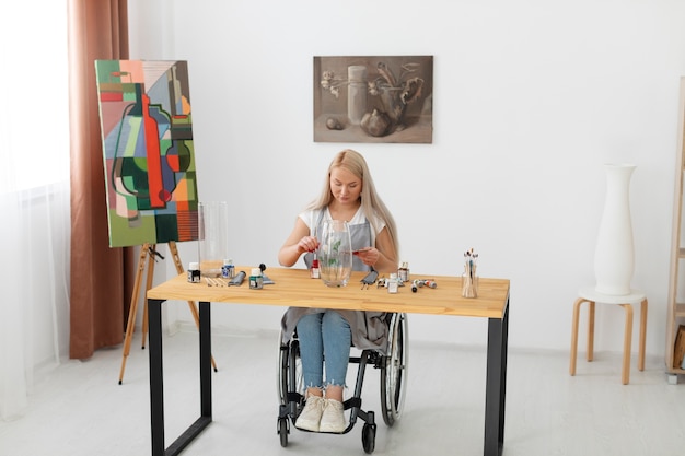 Disabled person in wheelchair painting