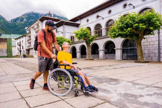 A disabled person in a wheelchair walking through the town square having fun with a friend