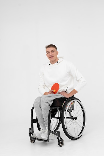 Photo disabled ping pong player in a wheelchair