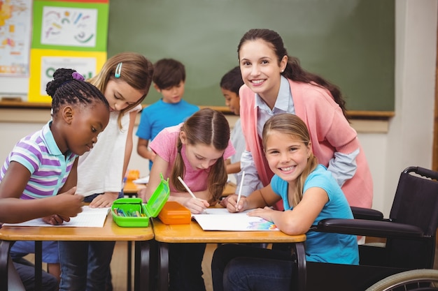 Disabled pupil smiling at camera in classroom