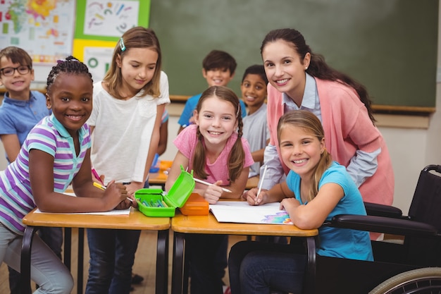 Disabled pupil smiling at camera in classroom