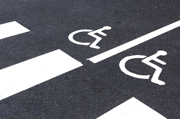 Disabled sign painted on grey asphalt