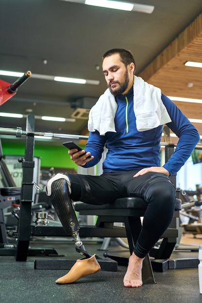 Disabled sportsman using his smartphone