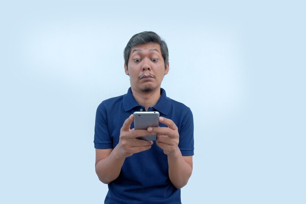 Disappointed face of man while looking phone screen