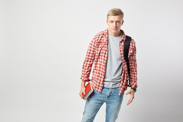 disappointed man standing with red book