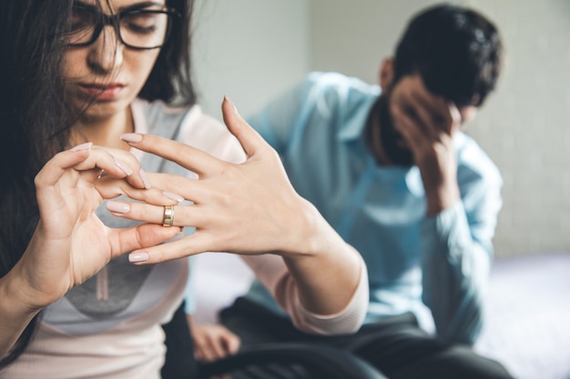 Disappointed woman returning wedding ring to her ex-husband